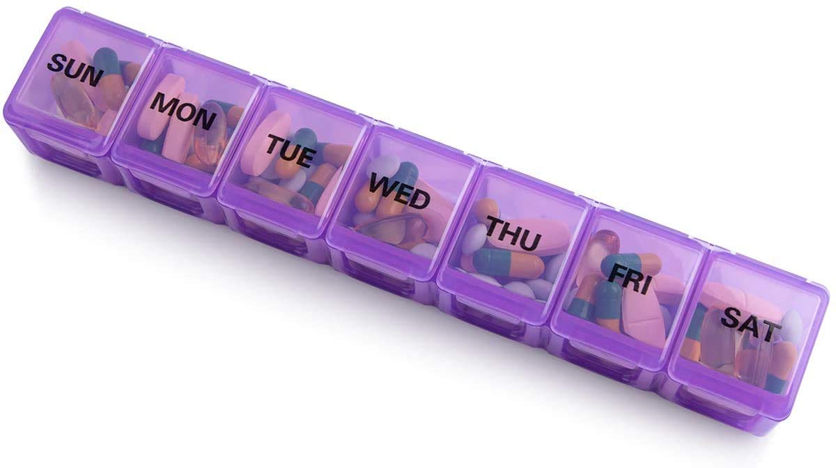 a plastic container with pills in it with text: 'SUN MON TUE WED THU FRI SAT'