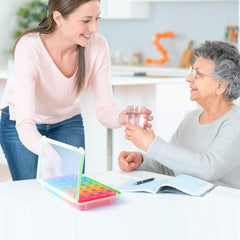 a person giving a glass of water to an old person