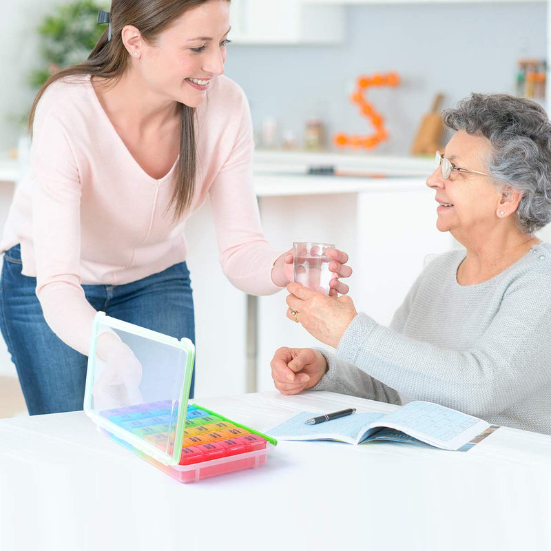 a person giving a glass of water to an old person