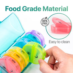 a hand holding a plastic container with different colored plastic containers with text: 'SUN MON TUE U WED FRI SAT Easy to clean Food Grade Material FREE BPA'